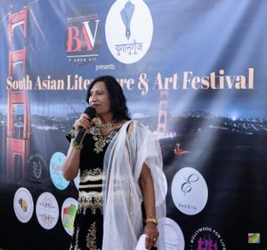 Performer speaking at cultural festival with Bay Bridge backdrop and sponsor logos.