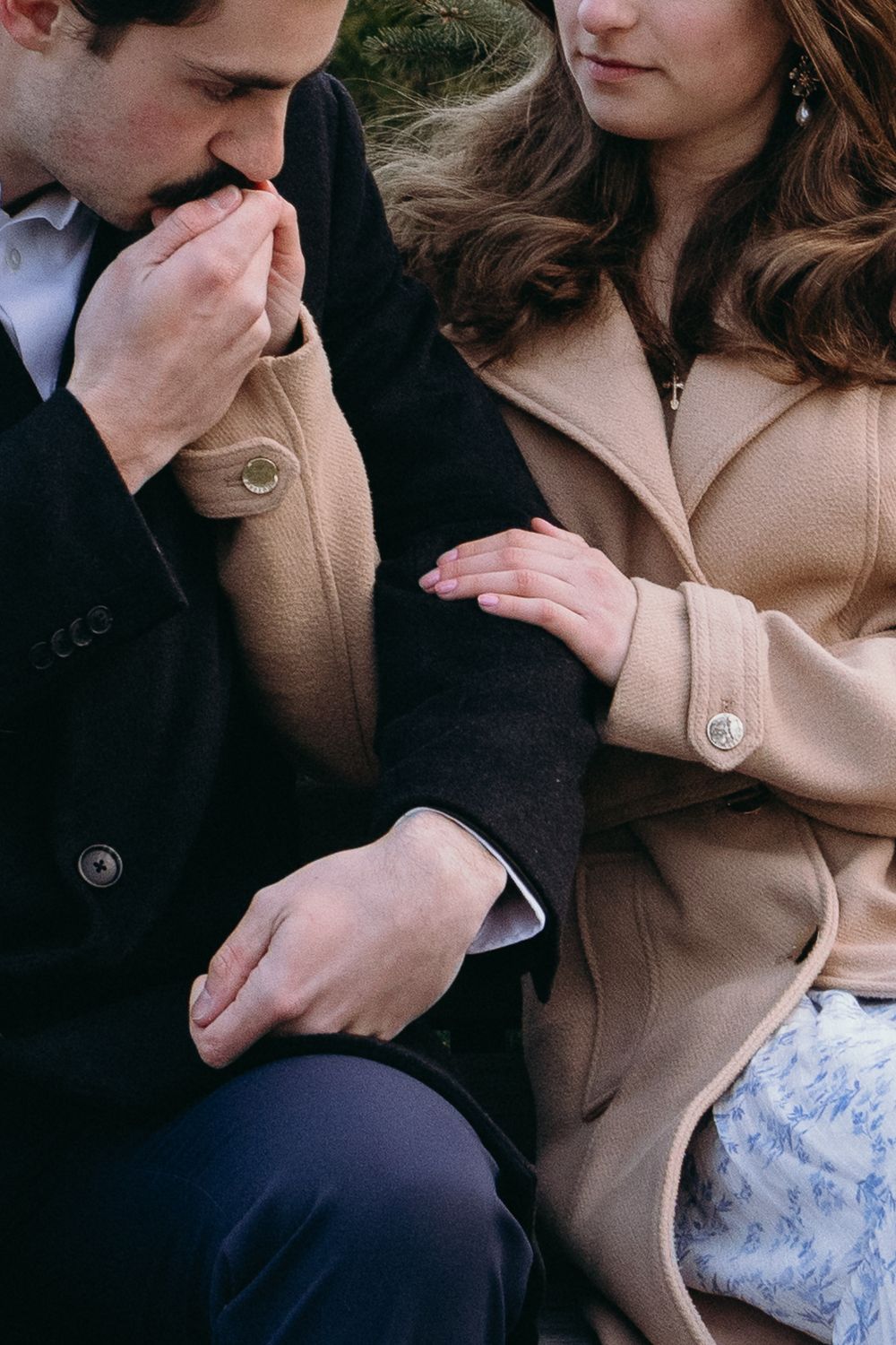 Close-up details of a couple's tender interaction while sitting on a park bench. Castle  Ladyhawke Wedding Photographer