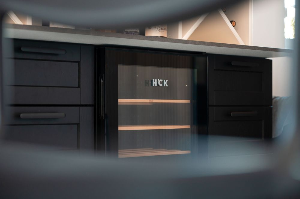 Dark modern entertainment unit with integrated lighting and sleek design elements.