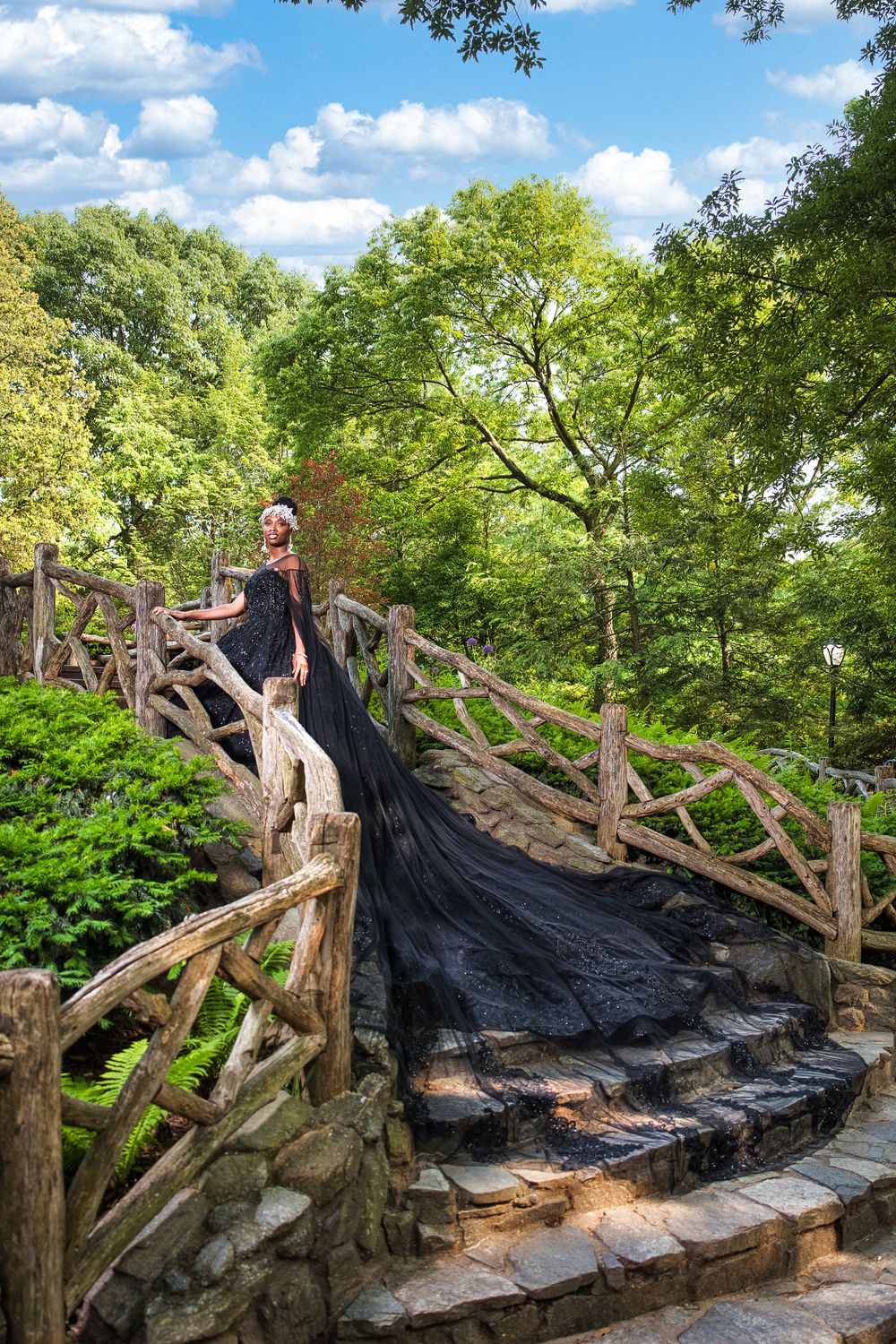 Black bride in black wedding dress standing on stairs in Central Park, NYC Photographer