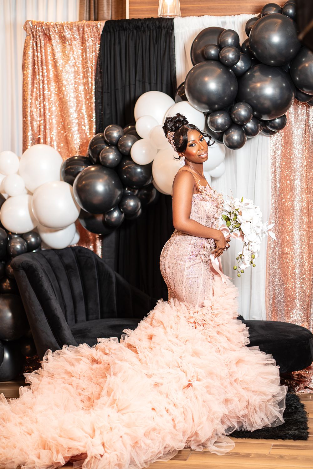 African bride in pink wedding gown in front of balloon wall, NYC photographer