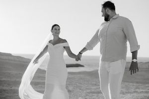A series of black and white photos showing people in white clothing dancing and moving together outdoors.