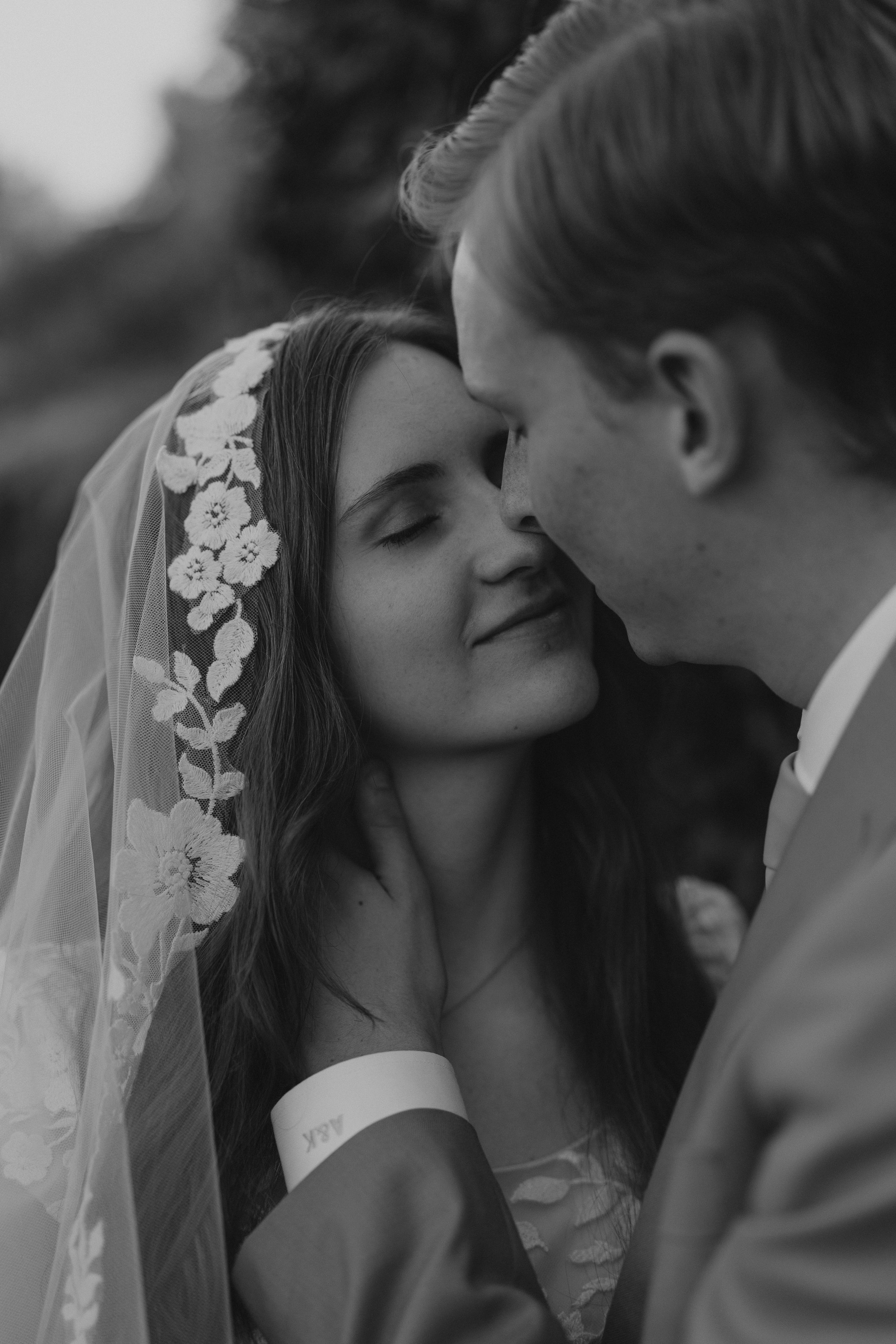 A romantic series of black and white wedding photos showing intimate close-up moments between newlyweds.