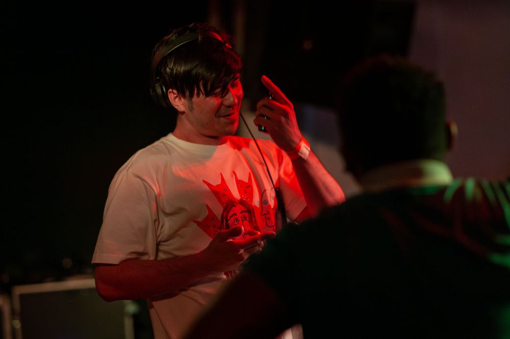 Dimly lit party scene with red lighting effects.