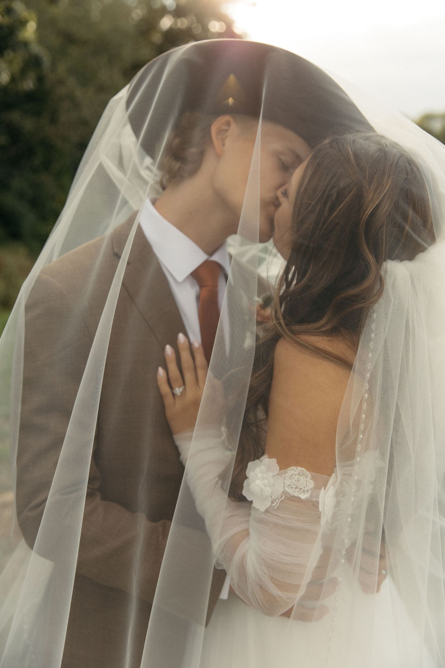 Newlyweds sharing a kiss during their western style outdoor wedding portrait session.