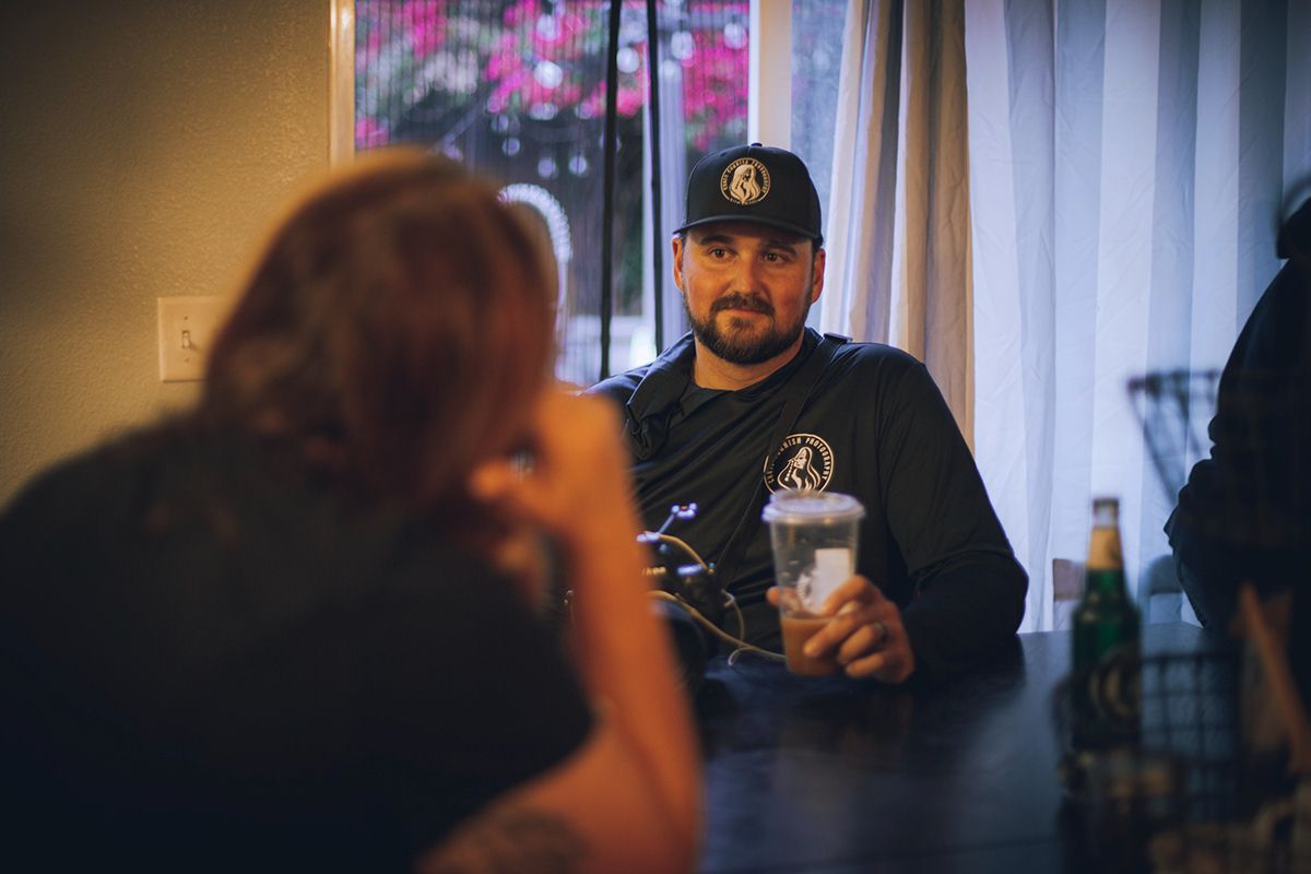 Chris Cornish, photographer, on the set for the short film I-16, speaking with a makeup artist on set