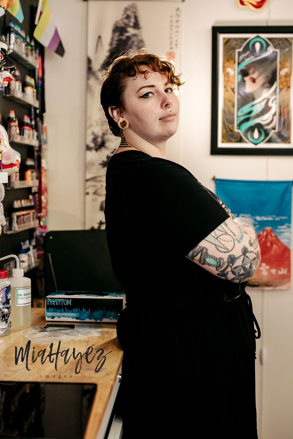 Professional photography studio interior with black decor and artistic wall displays.