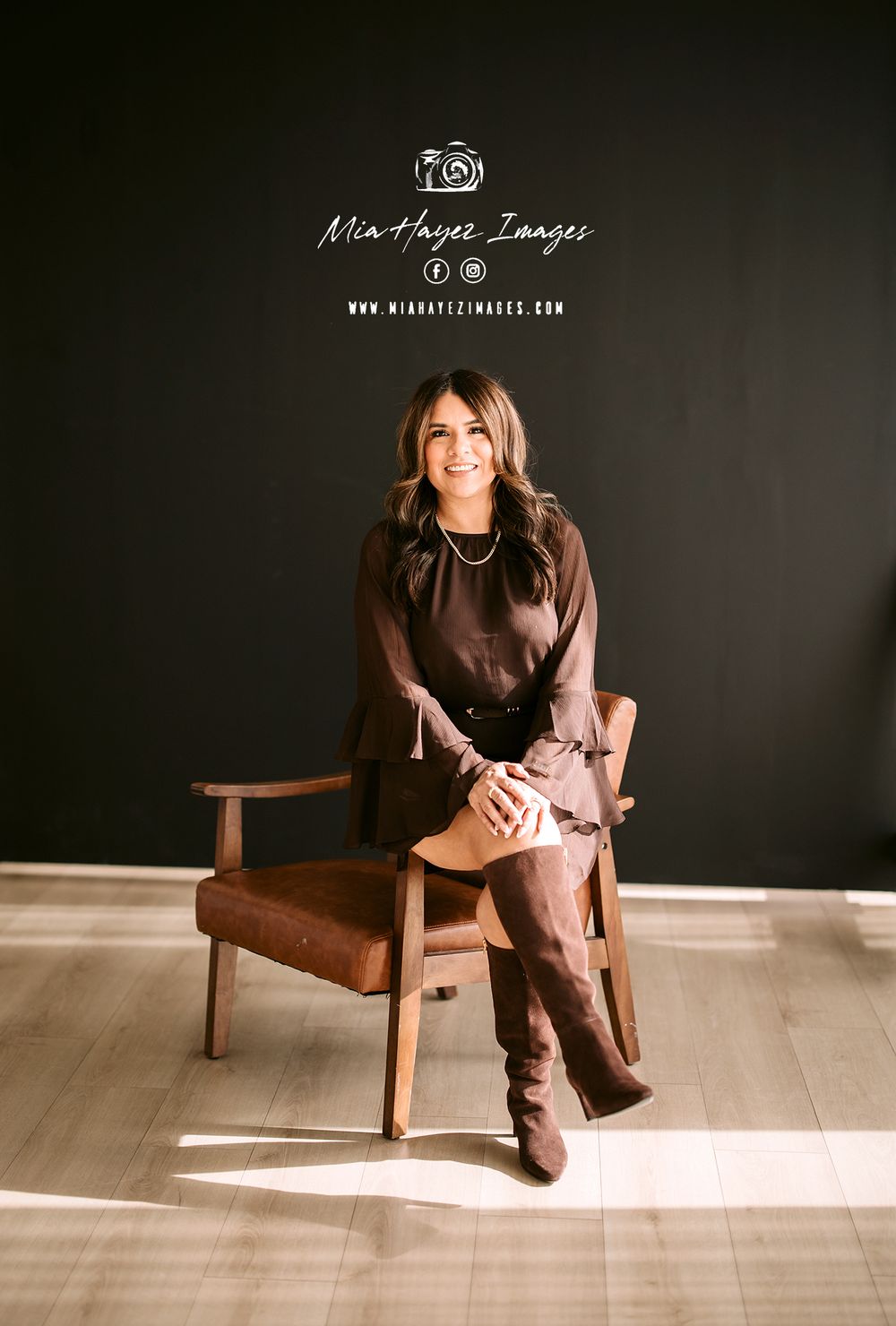 Lifestyle portrait session in brown tones featuring minimalist wooden chair and natural lighting.