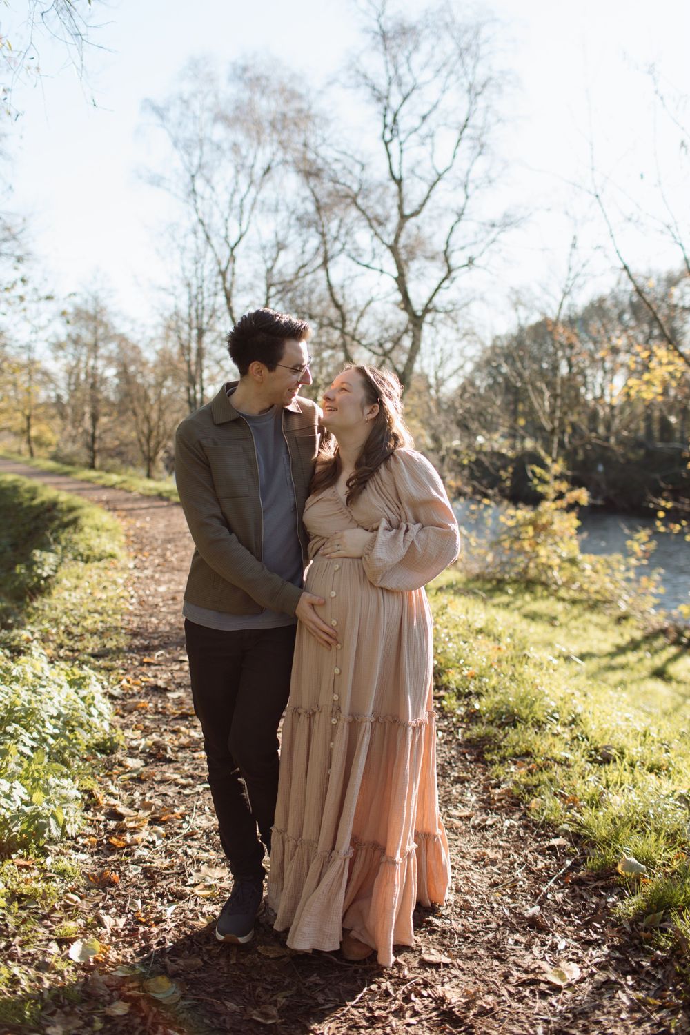 Couple walking down the Taff Trail in Cardiff, pregnant mum is wearing a dress from the photographer's client wardrobe.
