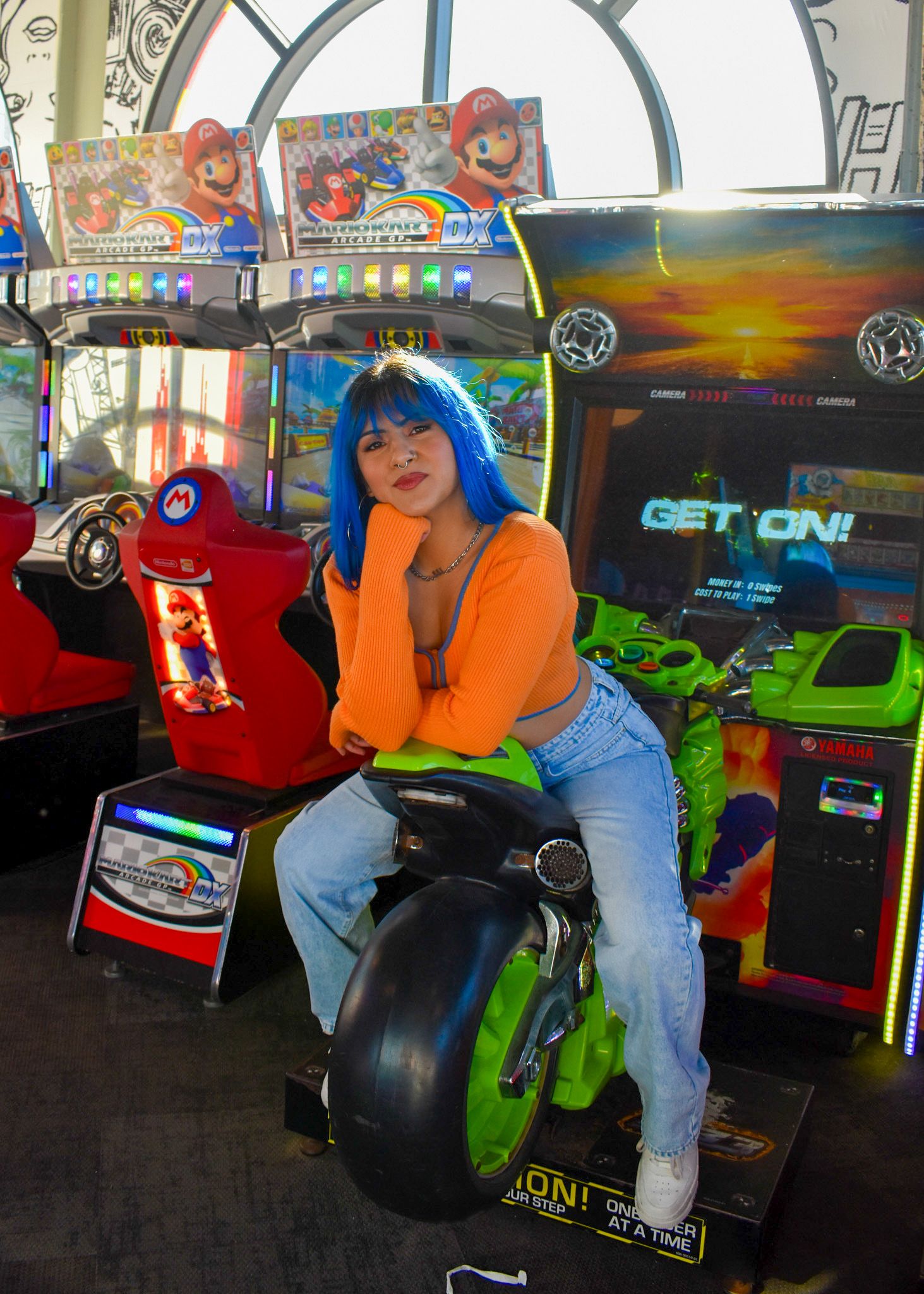 model posing on arcade bike
