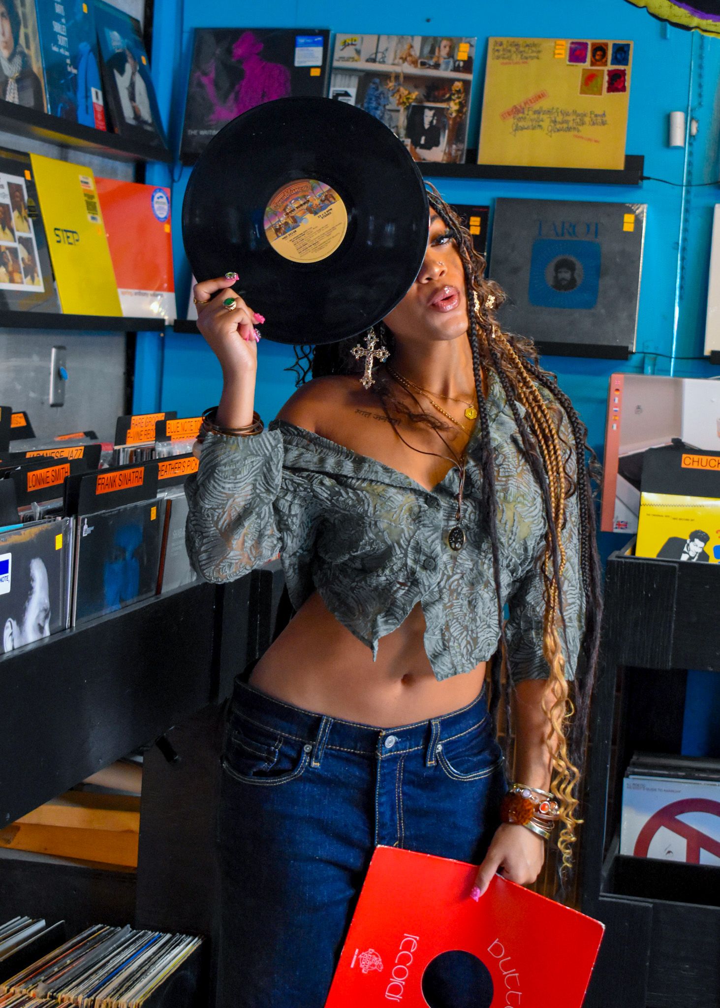 model posing with record in record store