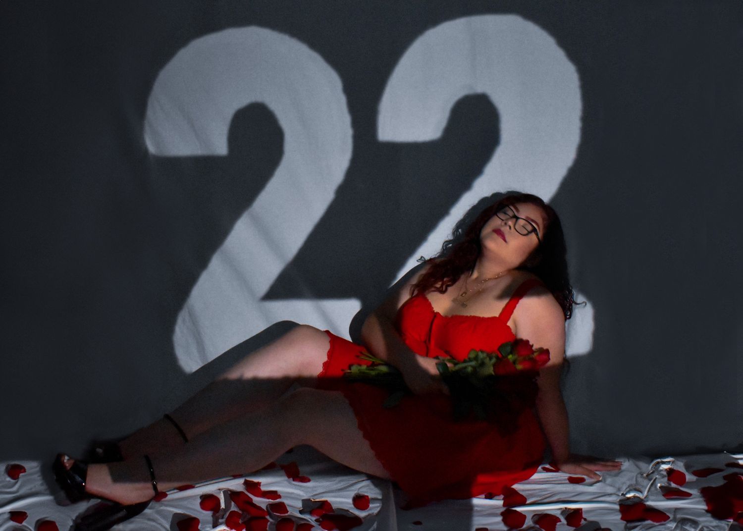 model posing with number 22 spotlight and roses