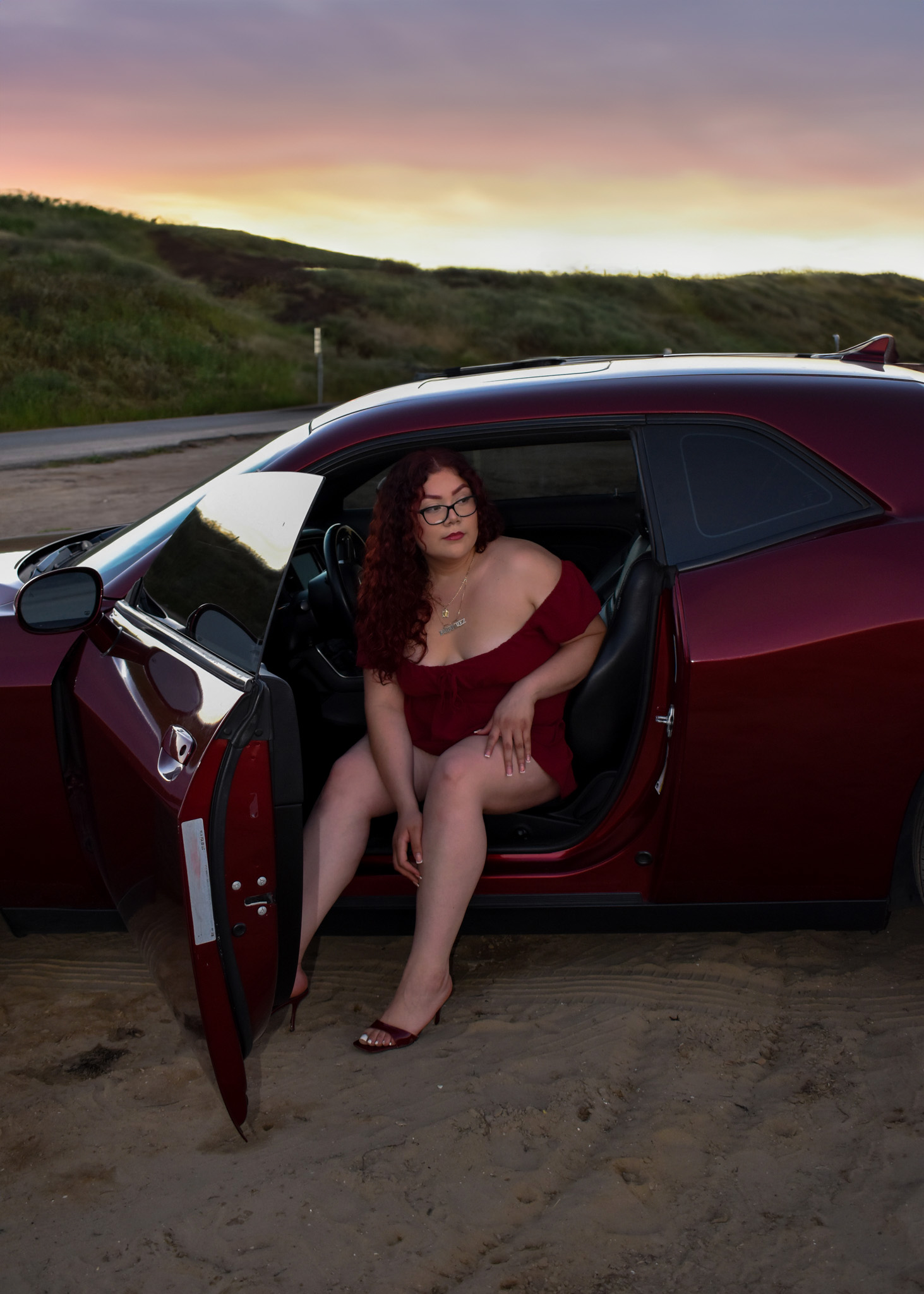 model posing with car inside with door open