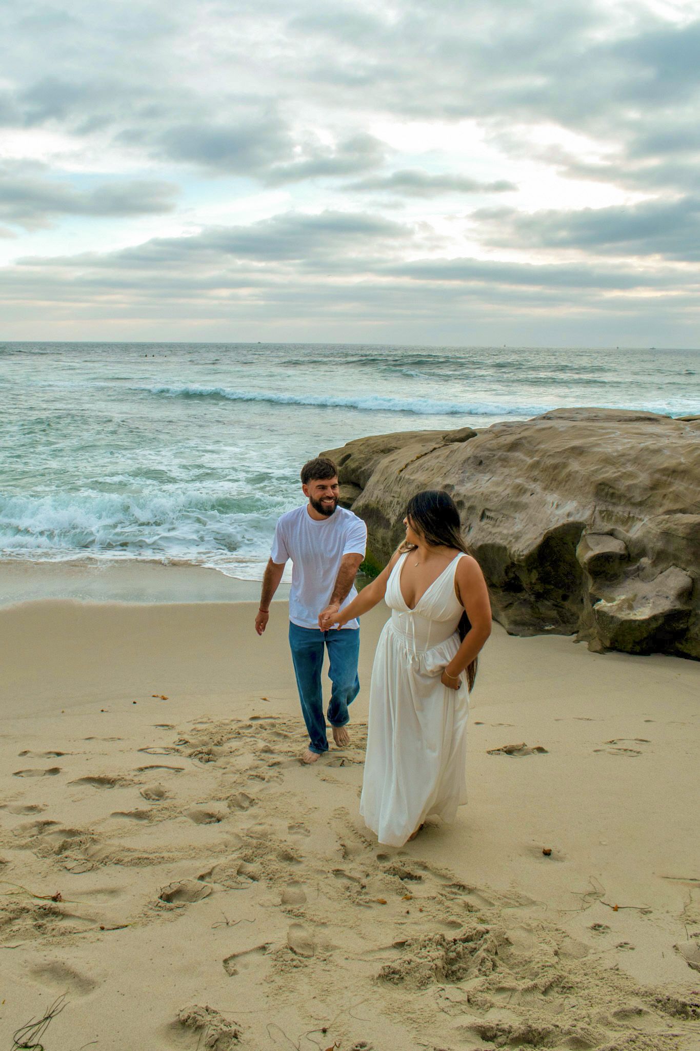 couple running together on beach