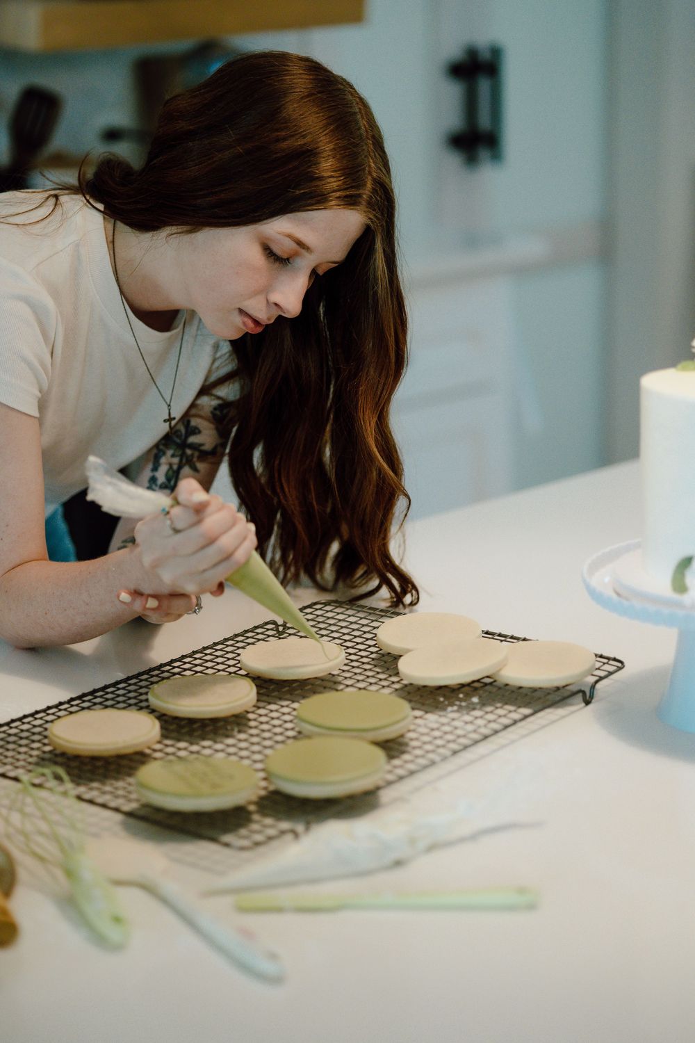 Detailed view of macaron decoration on a cooling rack in a modern kitchen.