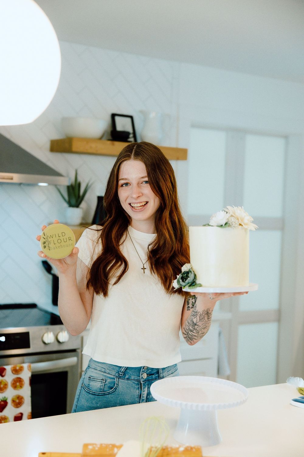 Bright kitchen interior with baking tools and a freshly decorated cake.