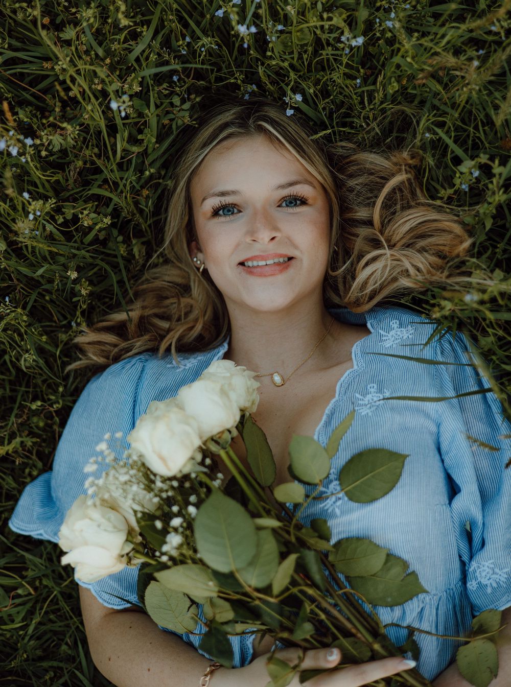 Ethereal outdoor photography with white roses and a light blue dress.