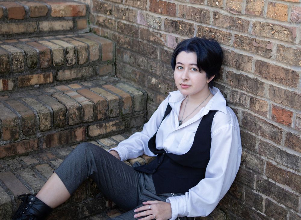 LGBTQ teen poses for their high school senior portraits in downtown Pensacola, FL showing their own style