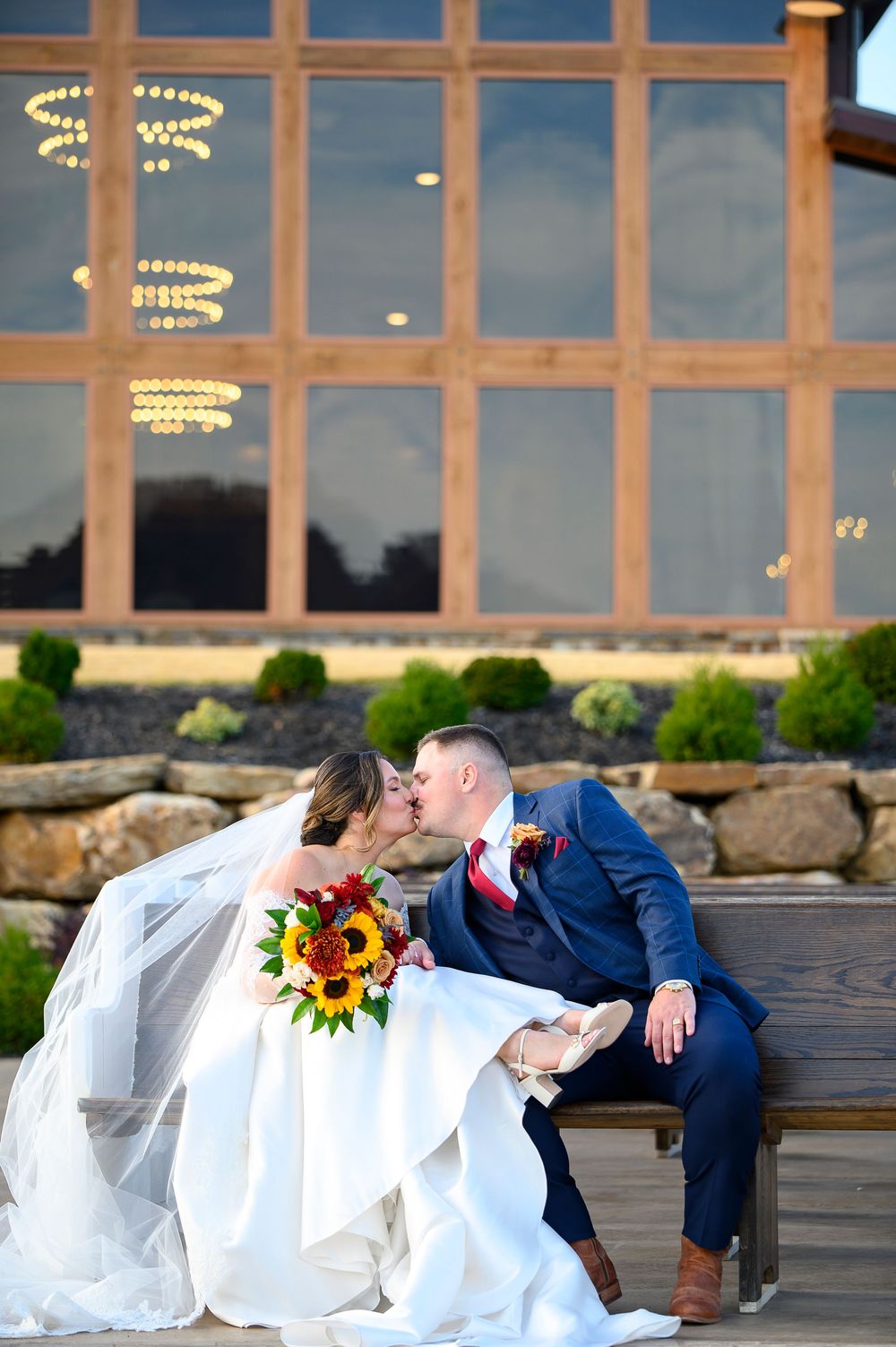 Romantic wedding couple poses for photos in a series of four artistic shots at sunset against a modern venue backdrop wedding photos in GA