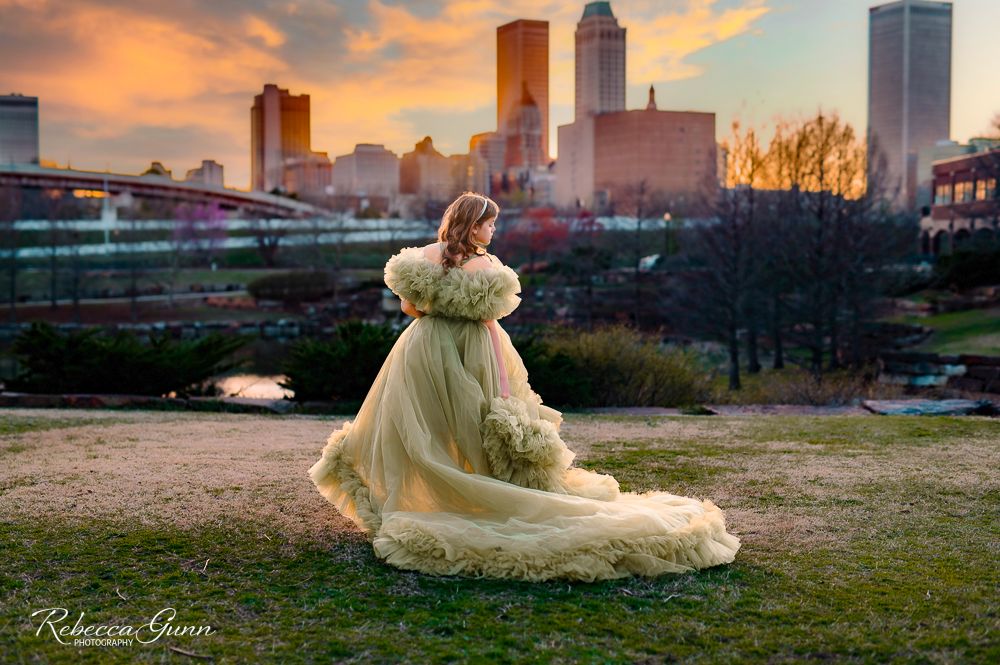 Child Couture olive green gown with taffeta and ruffle sleeves with downtown Tulsa Oklahoma skyline background; dream dress Bentley & Lace