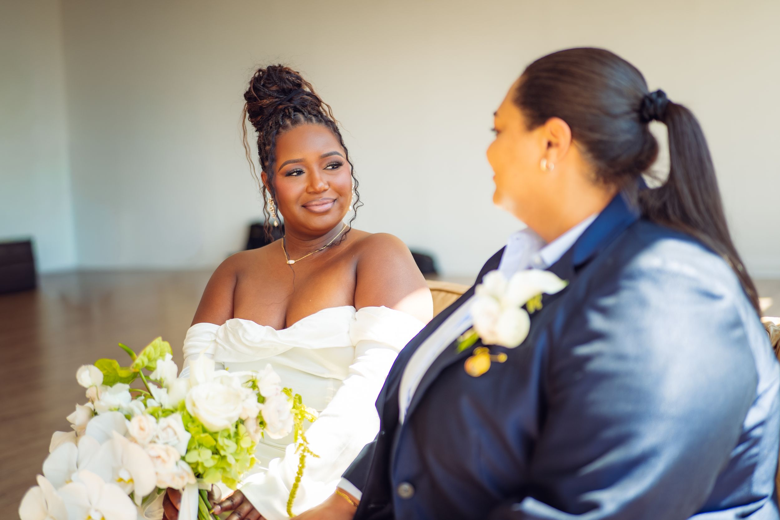 A candid moment between a couple on their wedding day sharing laughter.