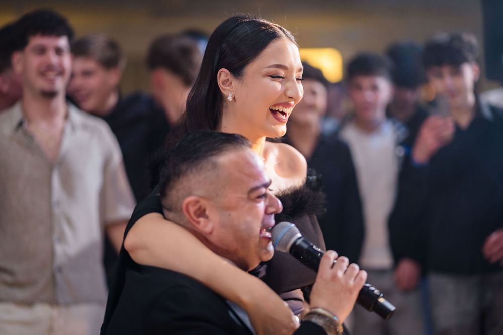 Performers entertaining a crowd at a formal indoor celebration.