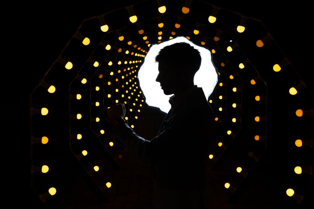 Decorative string lights create a spiral pattern against a dark background.