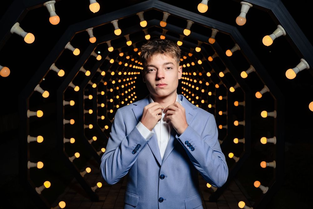 Modern fashion portrait with dramatic tunnel lighting effect in background.