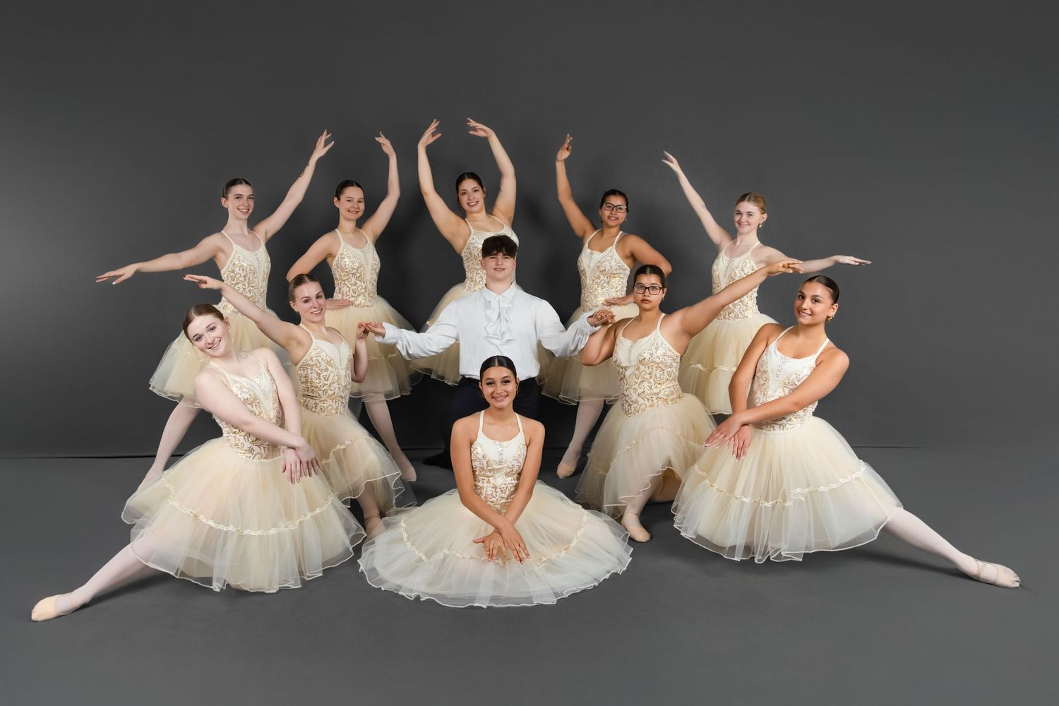 A dramatic dance performance shows a leap through the air while others watch on stage.