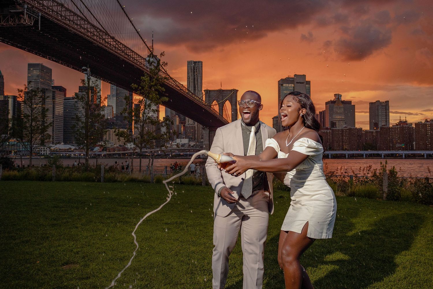 A sunset engagement photo with the Brooklyn Bridge and NYC skyline backdrop.