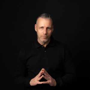 Professional headshot series of a person in black attire against dark background showing different contemplative poses.