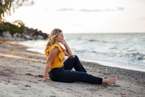 Senior session on the beach at golden hour.