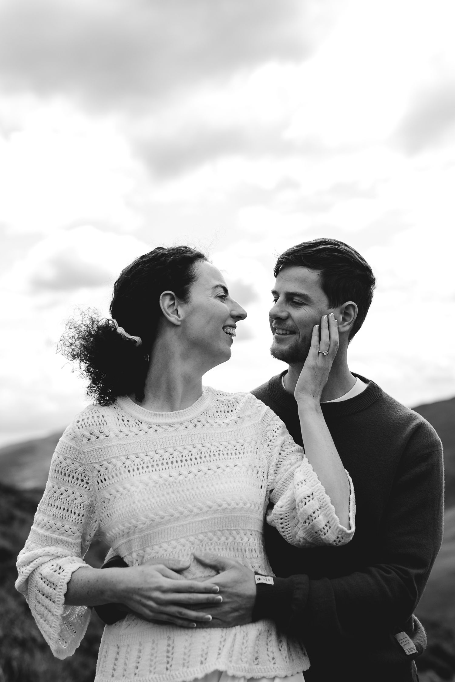 A series of romantic black and white photos showing a couple in an intimate embrace with the woman wearing a lace dress.