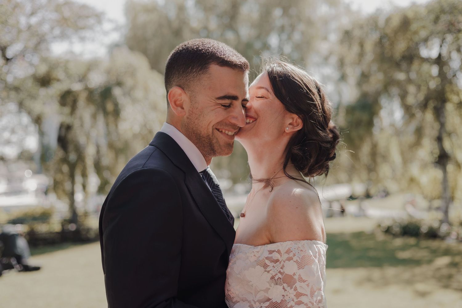 Couple kissing in a beautiful location after wedding