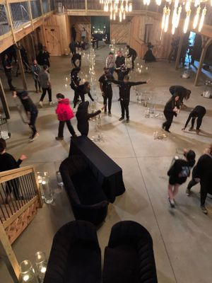 Overhead view of an event space with people mingling under hanging lights.