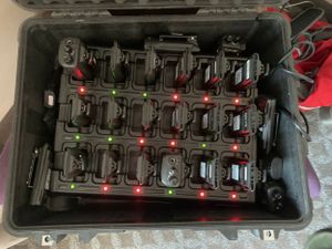 Black equipment case containing multiple organized battery packs with red indicator lights.