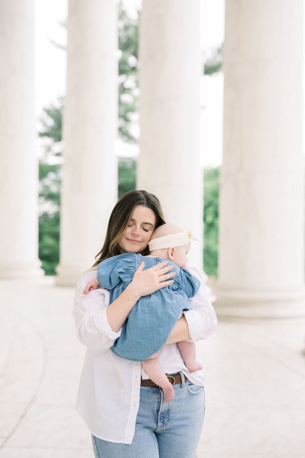 mother and daughter embraces at a family photo session at the Jefferson Memorial in Washington, DC