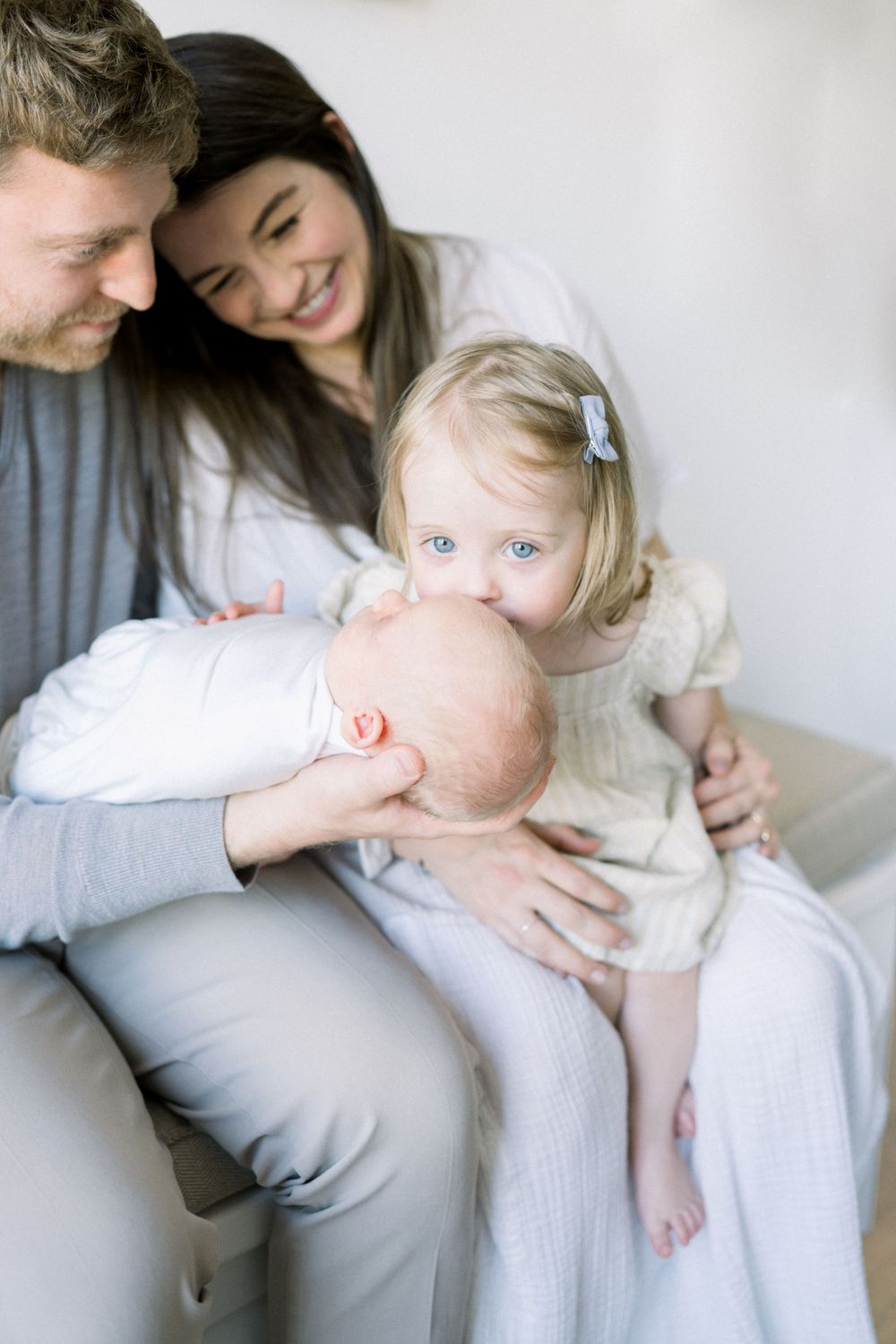 Parents kissing their newborn during a Washington DC in-home newborn session