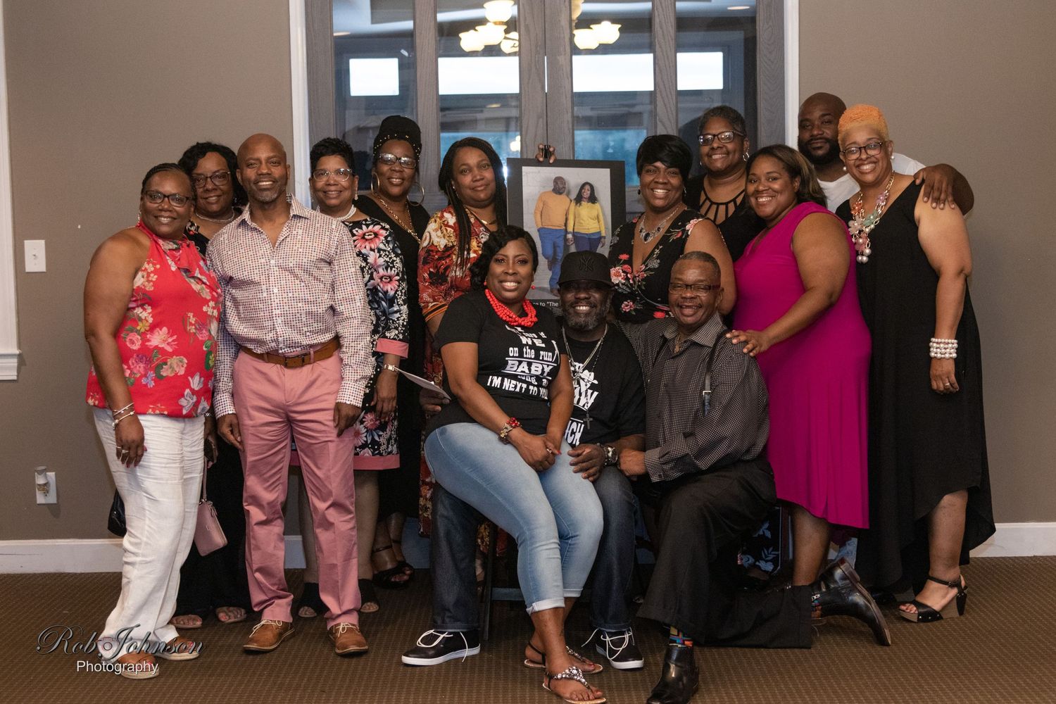 Large group photo of event attendees posing together in a spacious room.