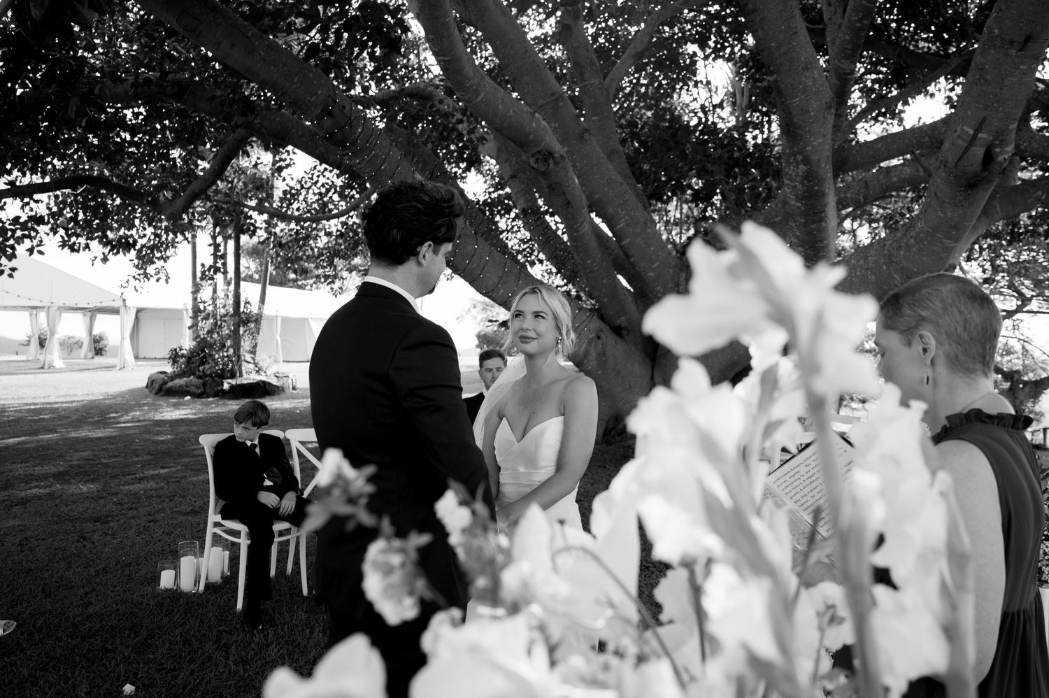 A black and white photo of a couple sharing a moment during an outdoor wedding ceremony at The Lookout, Woodbury.