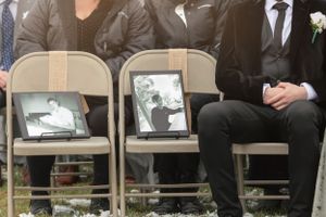 Memorial photos displayed on folding chairs at wedding ceremony.