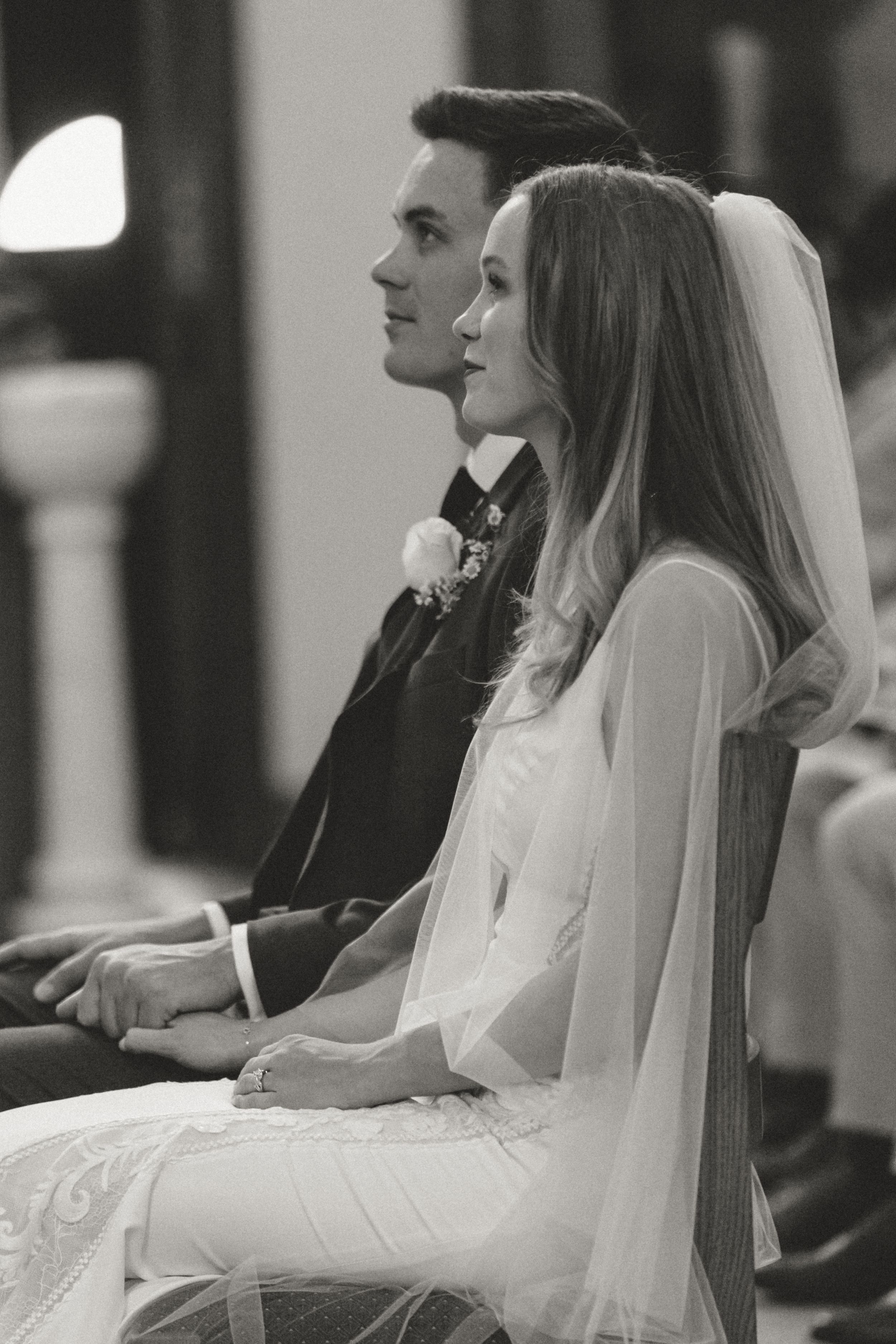 Classic black and white church wedding ceremony photos with bride in traditional veil.