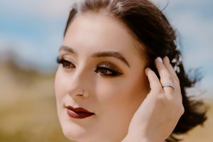 Elegant bridal beauty shot featuring burgundy lips and smokey eye makeup.