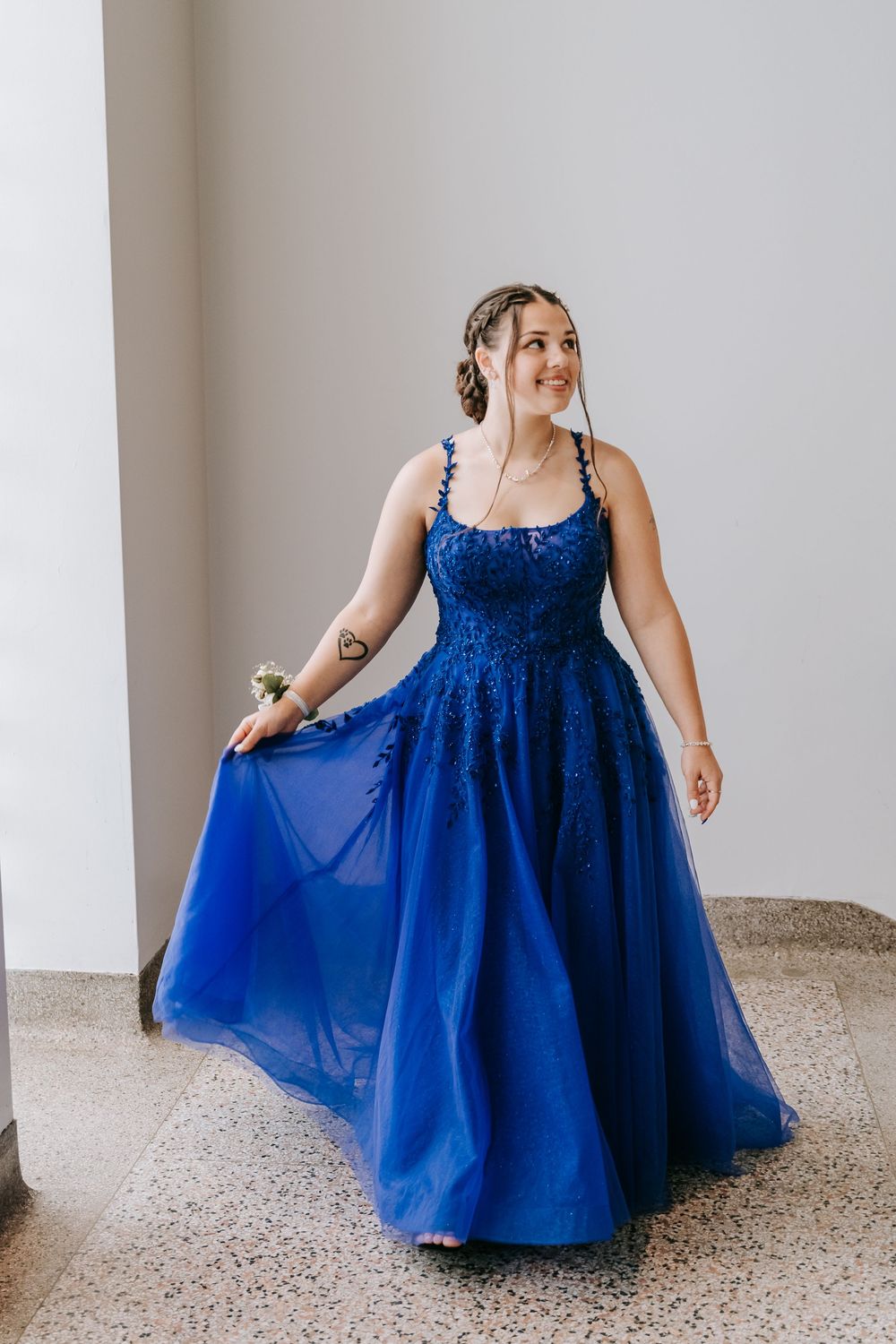 Elegant royal blue tulle formal dress showcased in various angles on light terrazzo flooring.