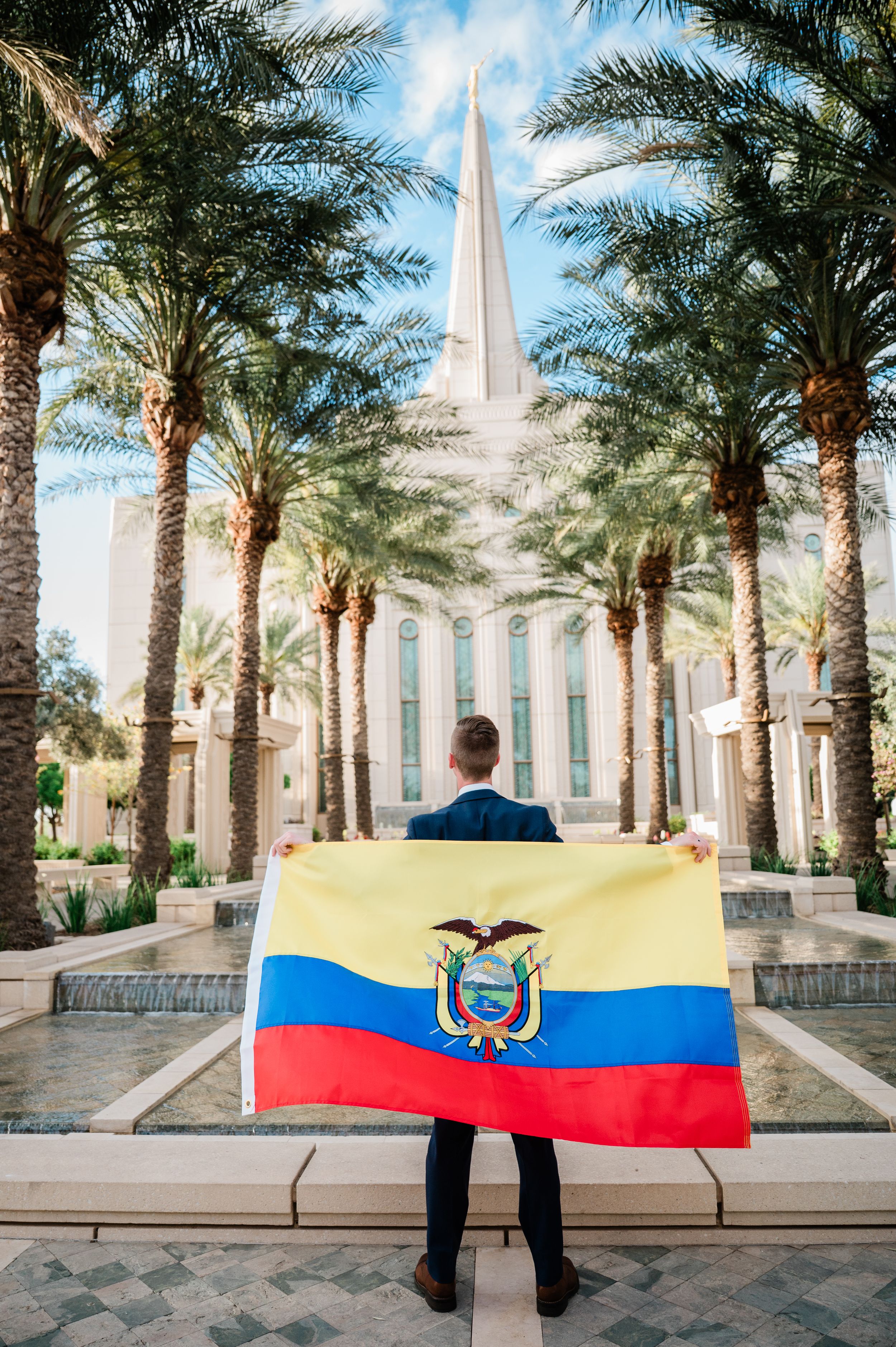 Gilbert Arizona photographer Melissa Maxwell of Jubilee Family Photography. Missionary holding Ecuador flag in front of Gilbert LDS temple.
