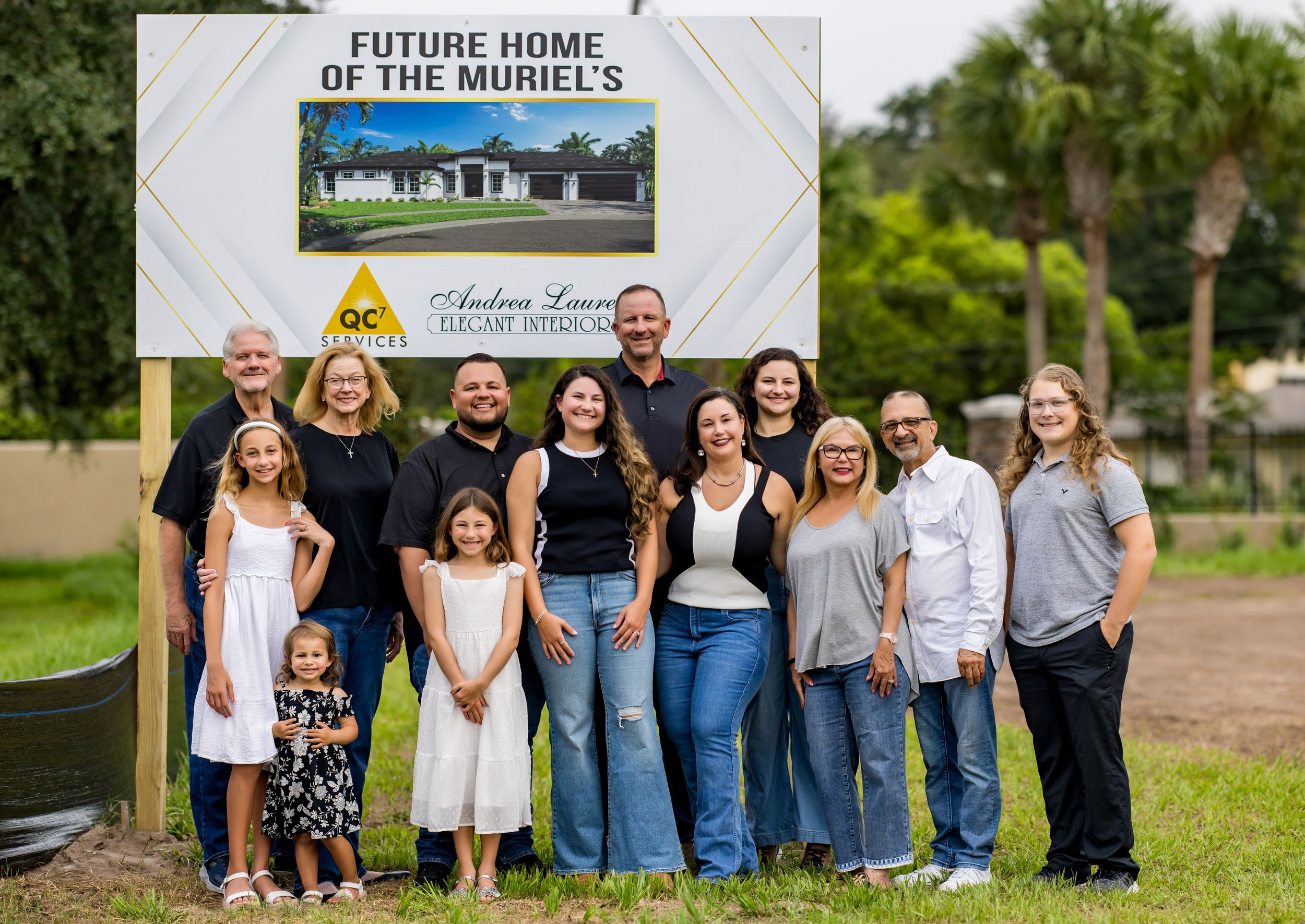 Group photo in front of Future Home construction site sign.