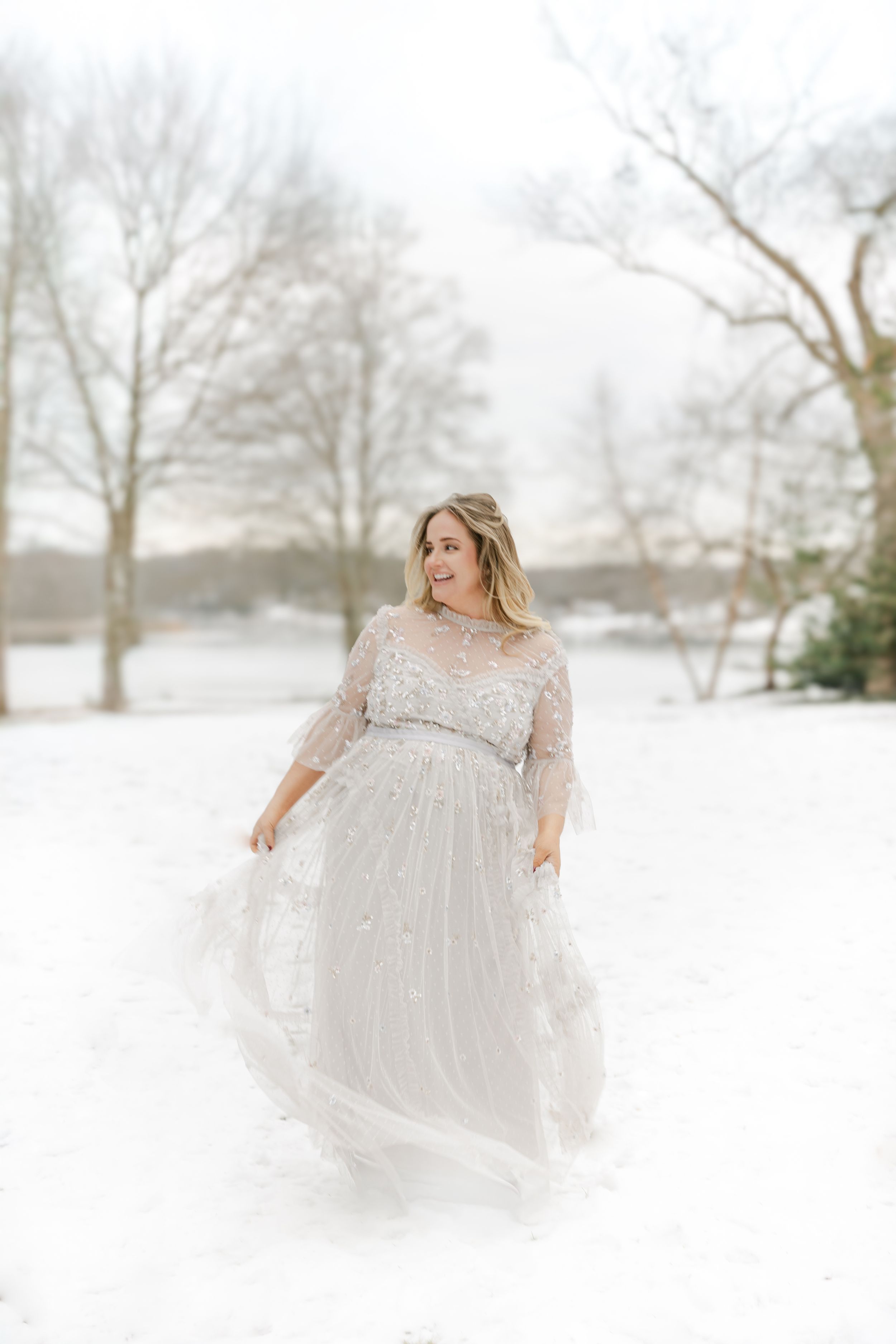 Ethereal maternity portraits in white lace gown against snowy winter landscape | Connecticut Maternity Photographer.