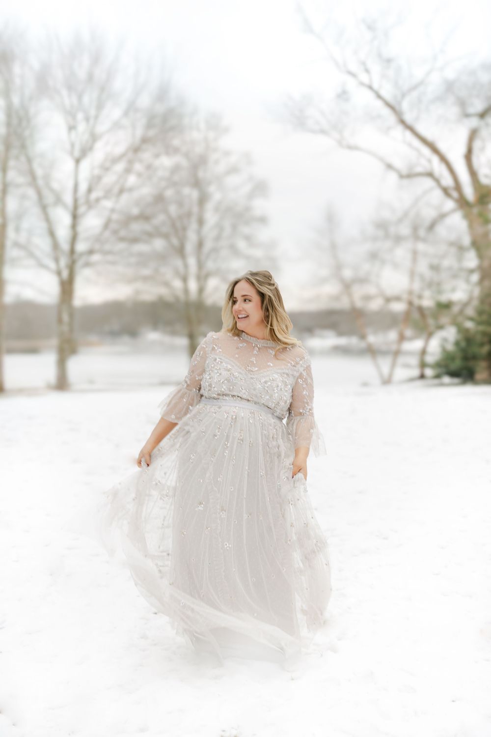 Ethereal maternity portraits in white lace gown against snowy winter landscape | Connecticut Maternity Photographer.