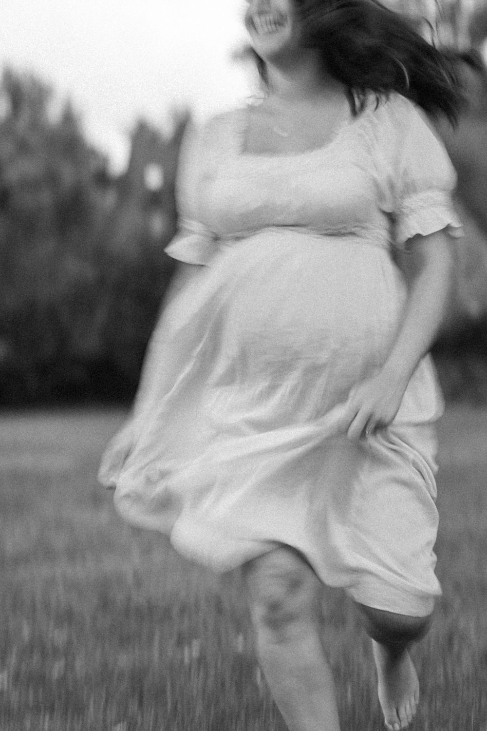 Pregnant mom jogging in her front yard | Connecticut Maternity Photographer.