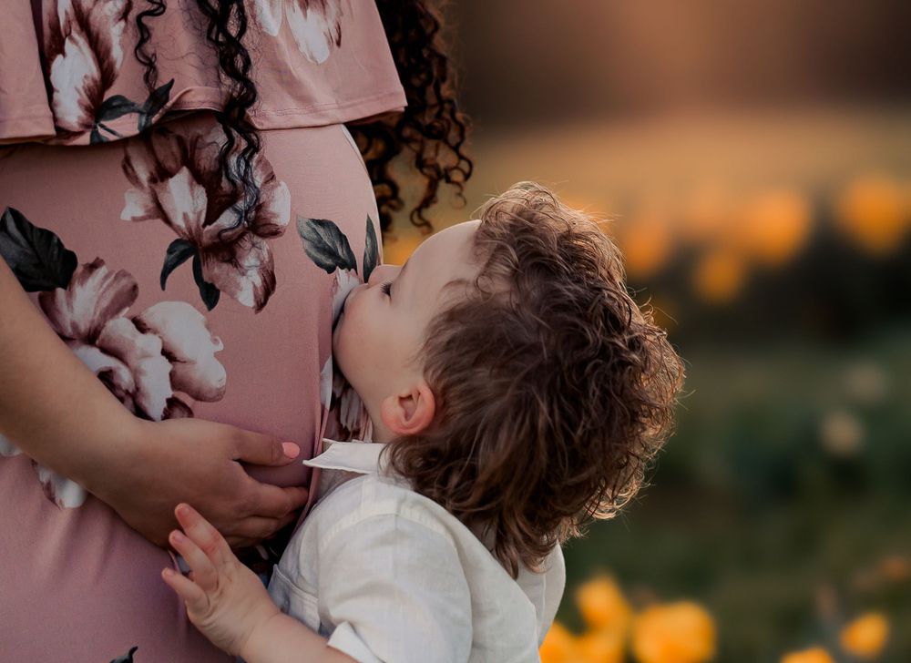 Intimate couple portraits captured among blooming daffodils at sunset.